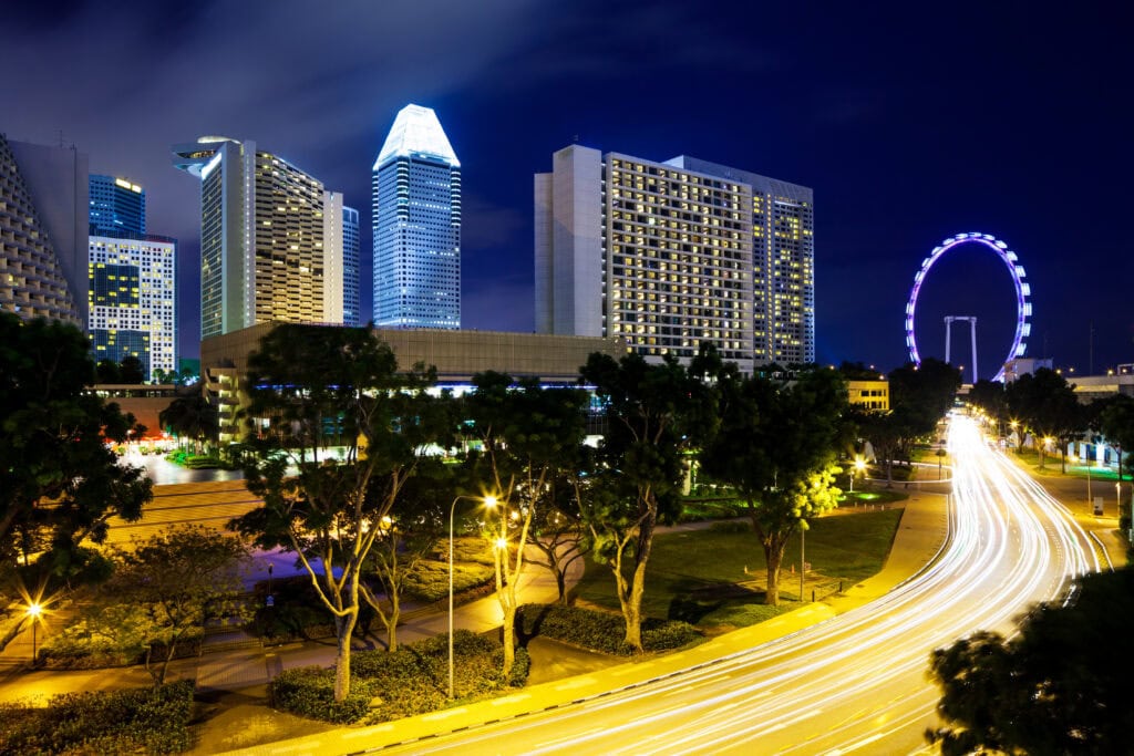 Illuminated cityscape with light trails.