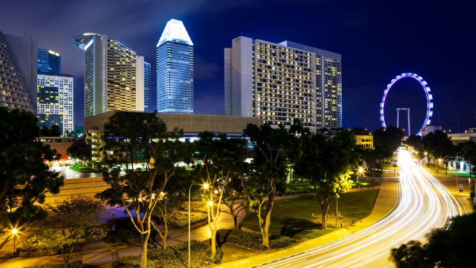 Illuminated cityscape with light trails.