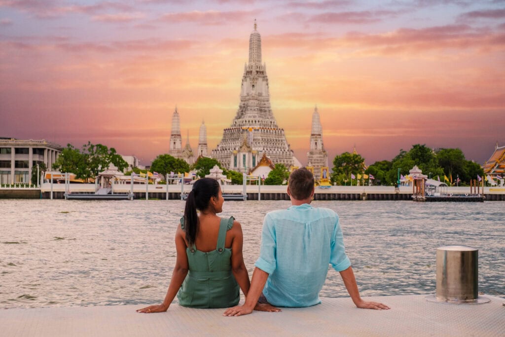 Couple enjoying sunset by temple.