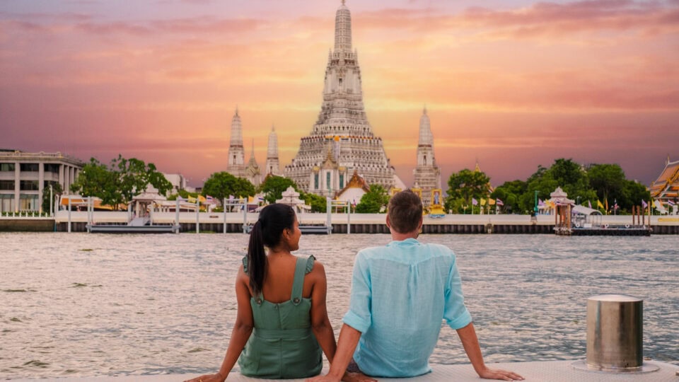 Couple enjoying sunset by temple.