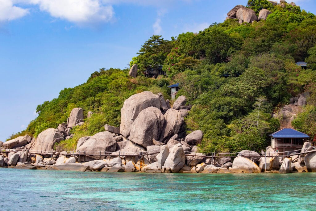 Rocky coastline with lush greenery.