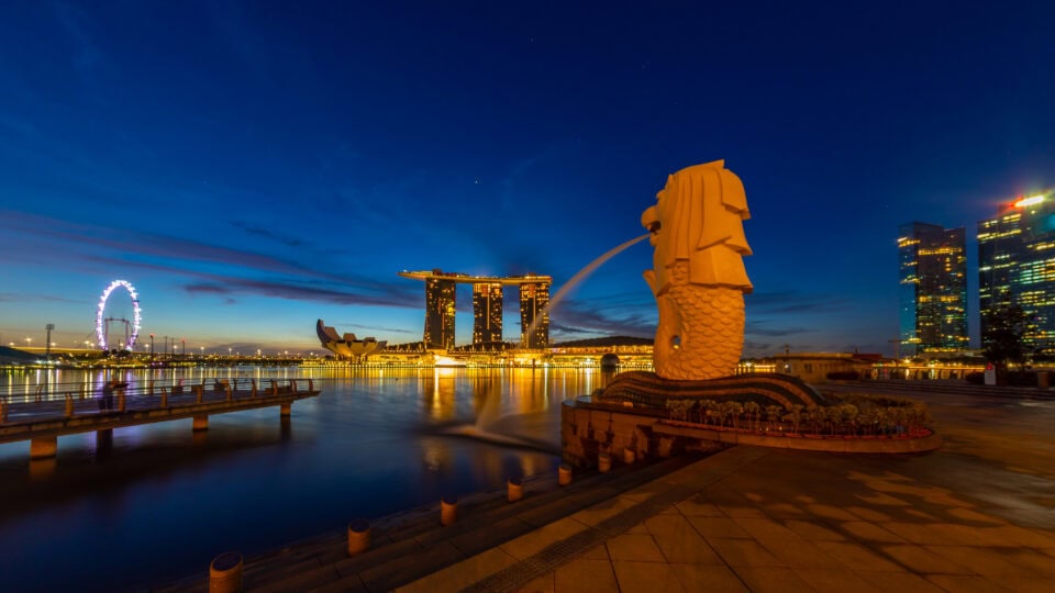 Merlion statue with city skyline backdrop