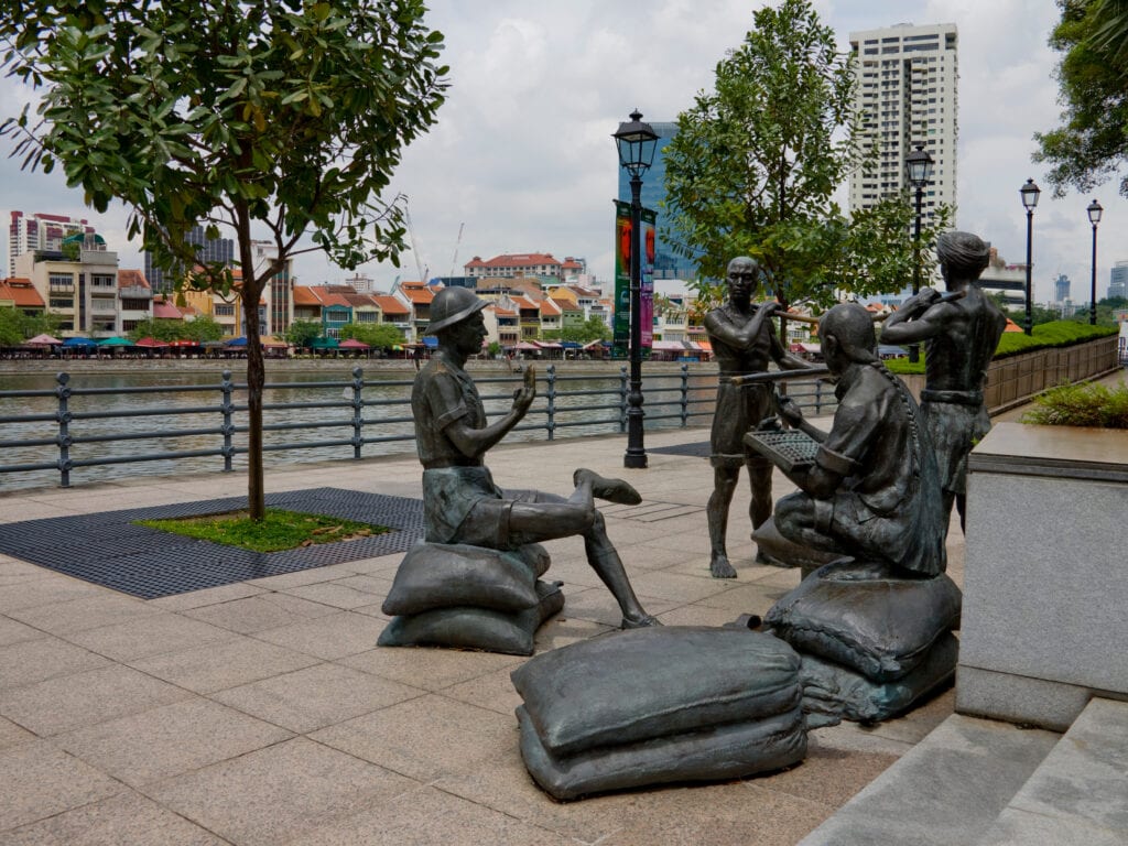 Bronze statues by the riverbank.