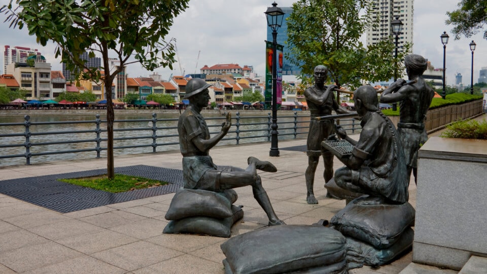 Bronze statues by the riverbank.