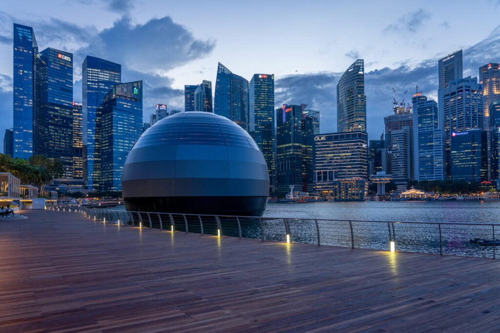 Modern skyline with futuristic dome structure.