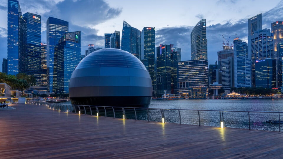 Modern skyline with futuristic dome structure.