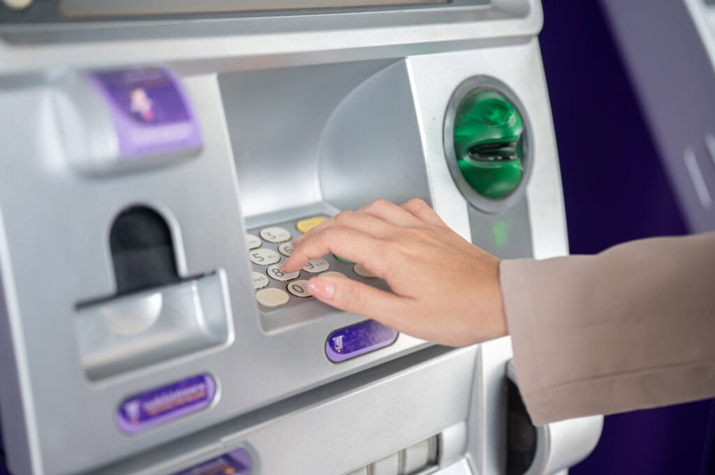 Hand pressing buttons on ATM