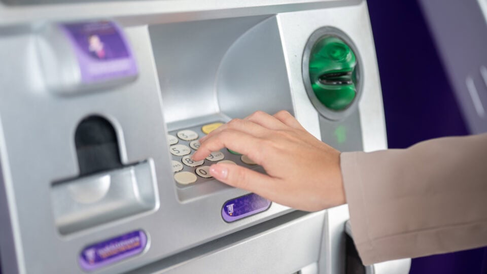 Hand pressing buttons on ATM
