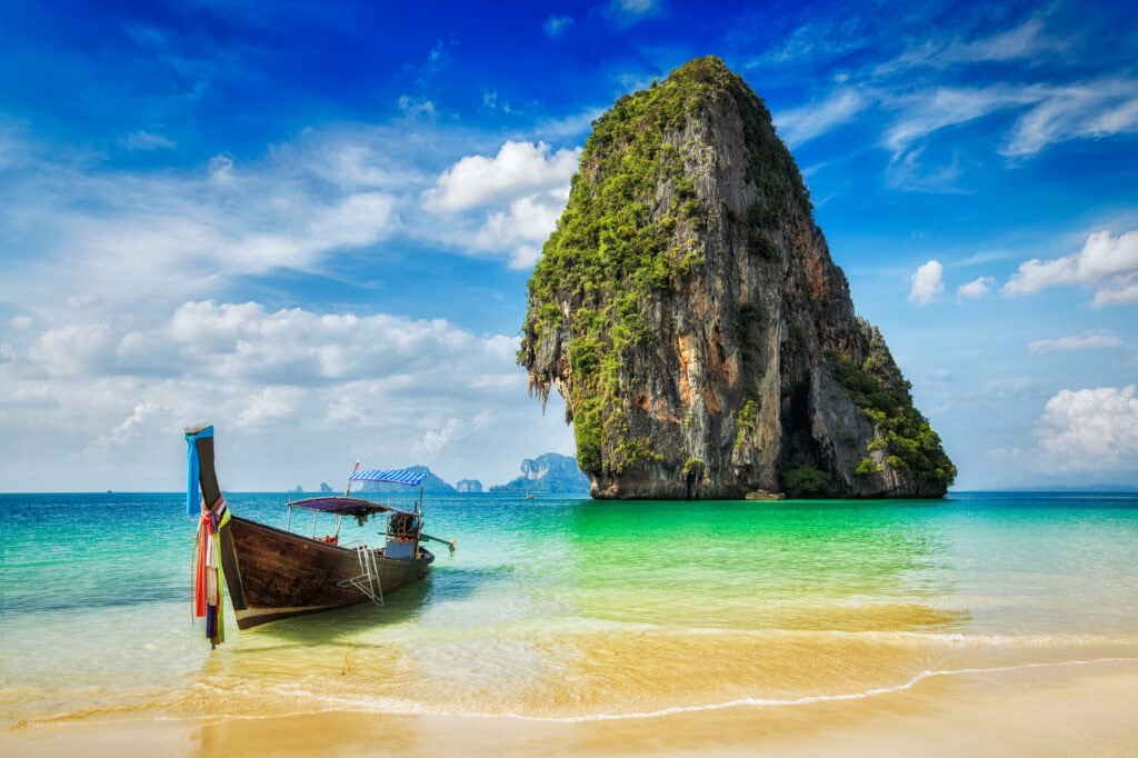 Long-tail boat near tropical island.