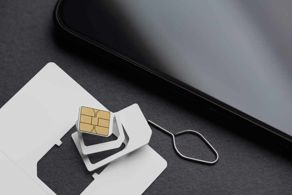 SIM card and eject tool on surface