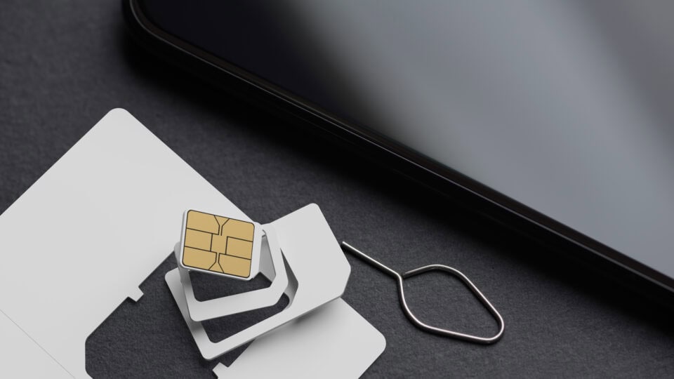SIM card and eject tool on surface