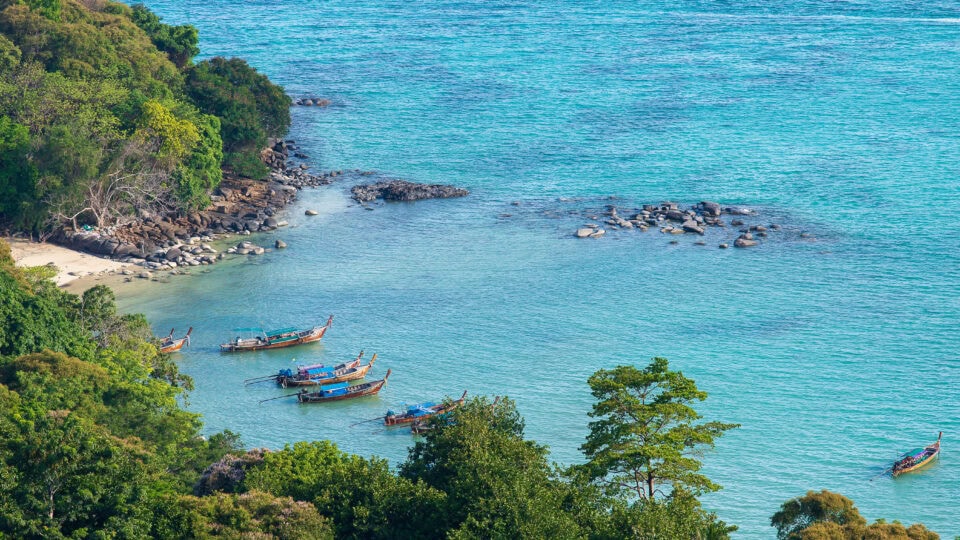 Boats anchored in a serene bay.