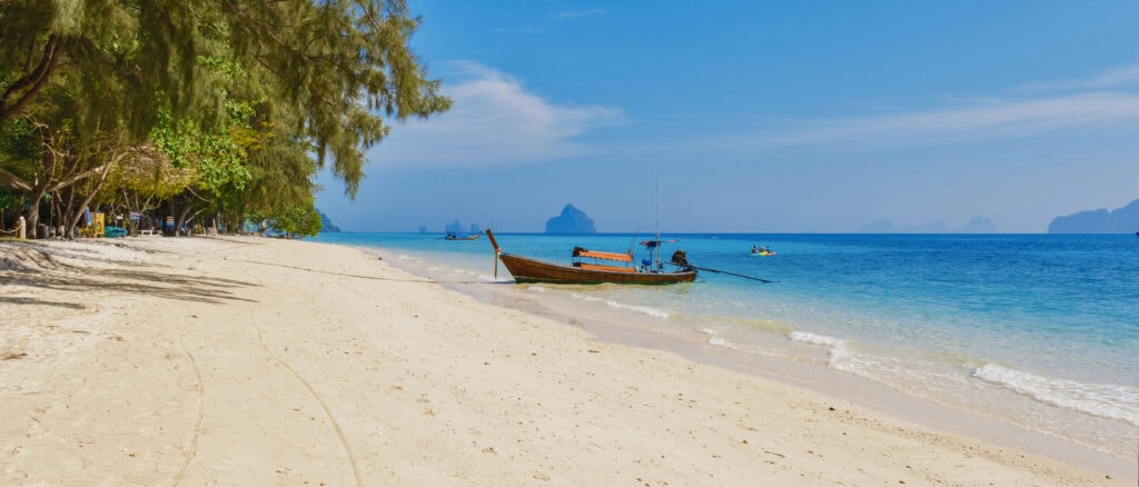 Tranquil beach with a boat.