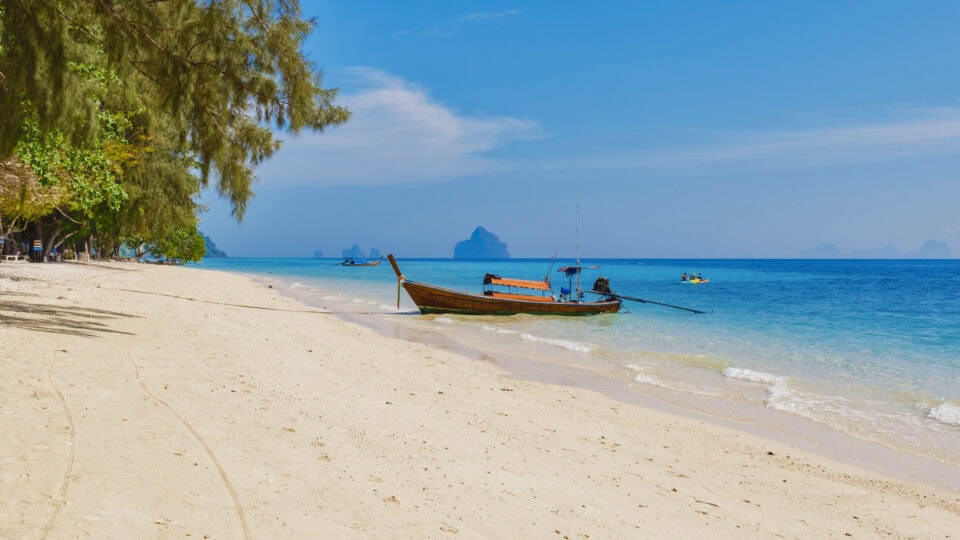 Tranquil beach with a boat.