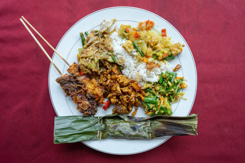 Colorful plate of Indonesian dishes.