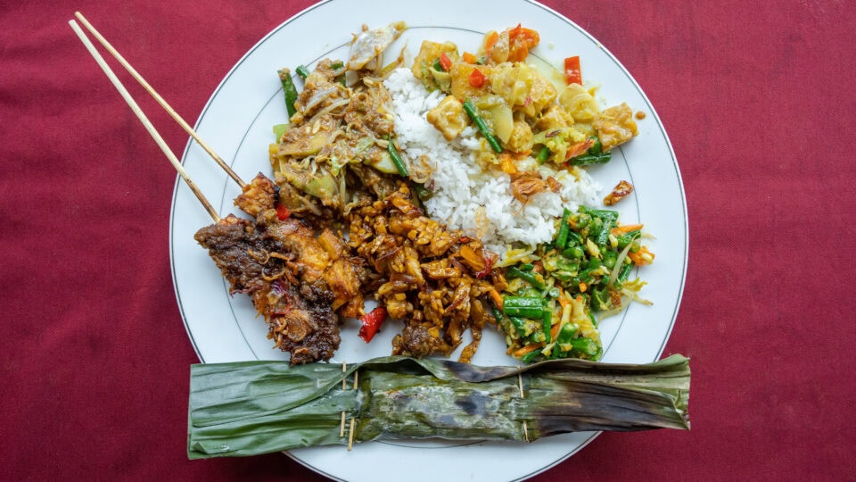 Colorful plate of Indonesian dishes.