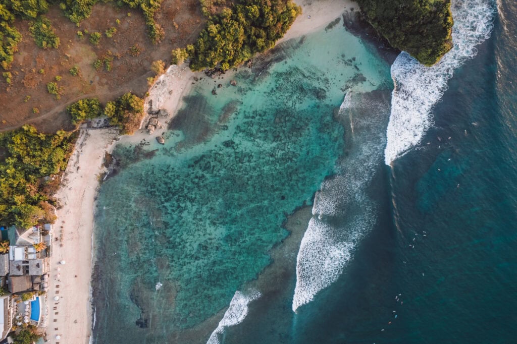 Turquoise waters and sandy beach.