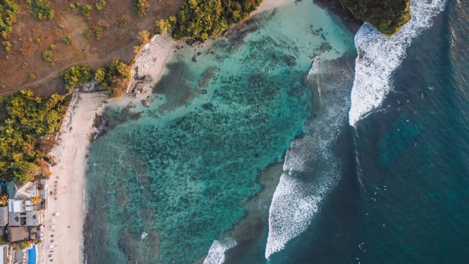 Turquoise waters and sandy beach.
