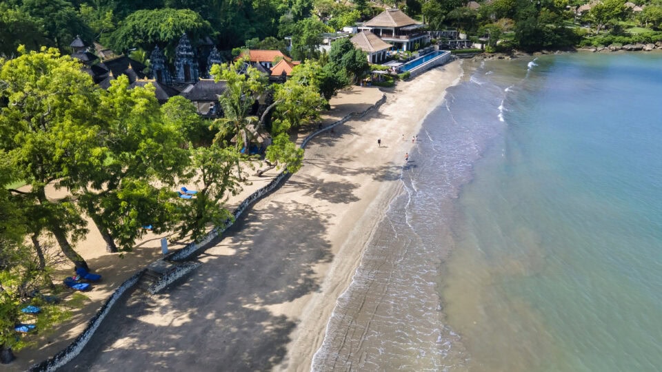 Serene beach with lush greenery.