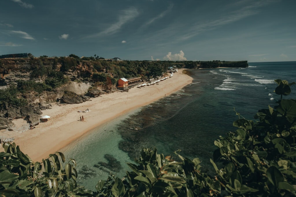 Serene beach with clear blue waters.