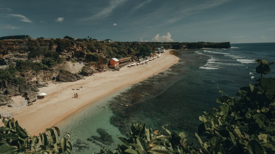 Serene beach with clear blue waters.