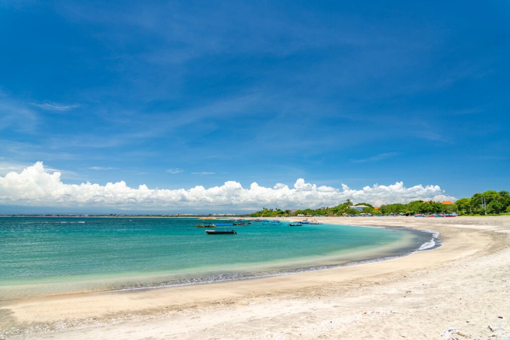 Sunny beach with clear blue water