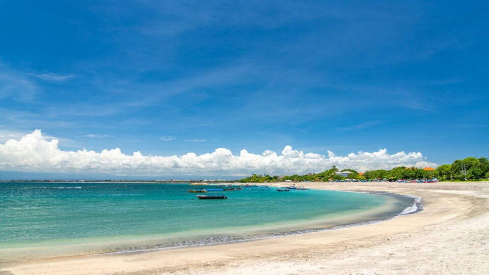 Sunny beach with clear blue water