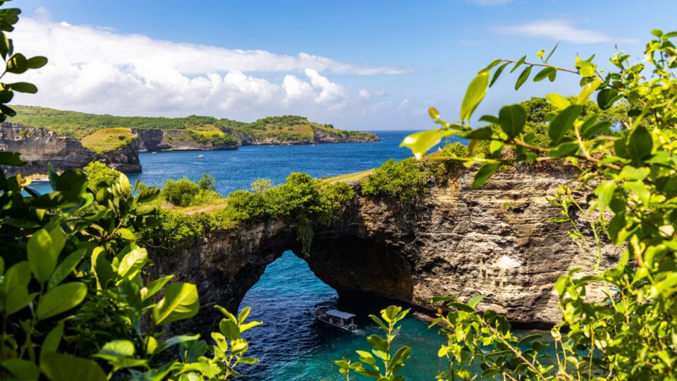 Scenic coastal view with archway.