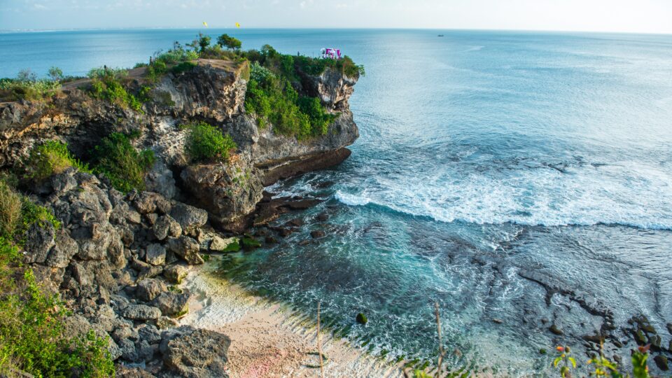 Cliffside view of serene beach.