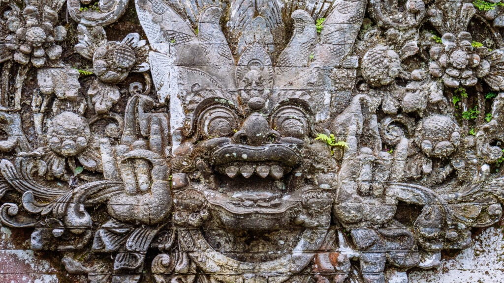 Intricate Balinese stone sculpture detail.