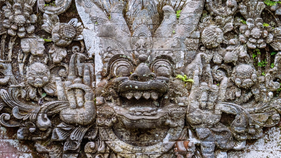 Intricate Balinese stone sculpture detail.
