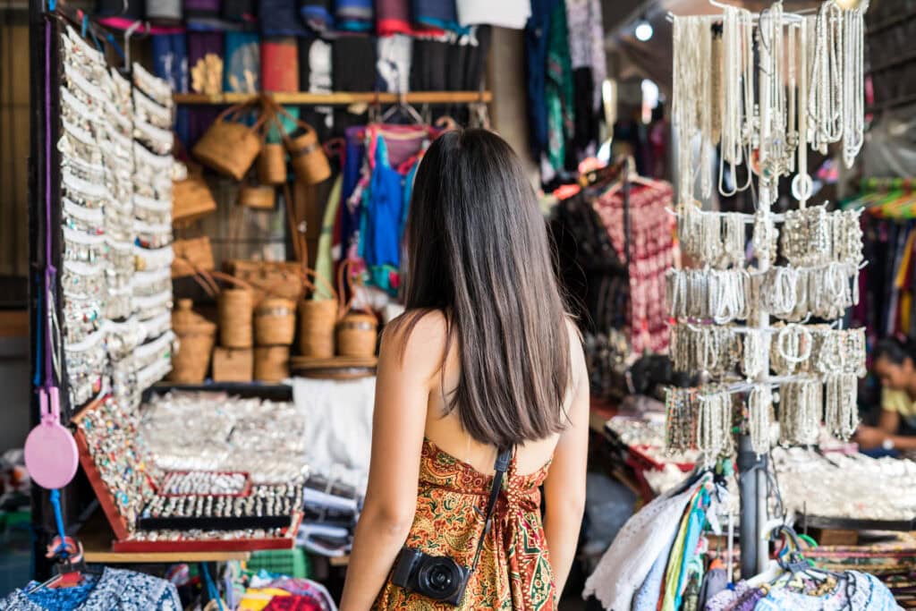 Woman exploring vibrant market stalls.
