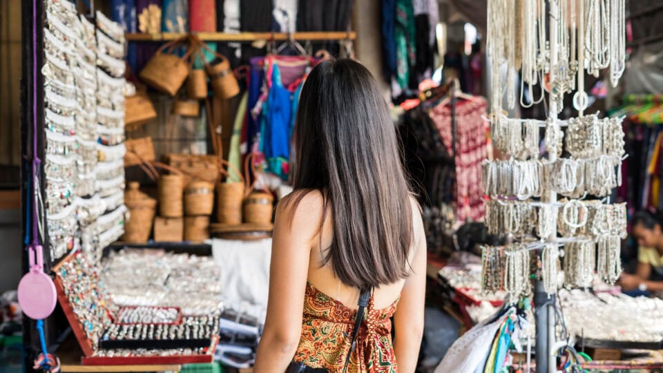 Woman exploring vibrant market stalls.
