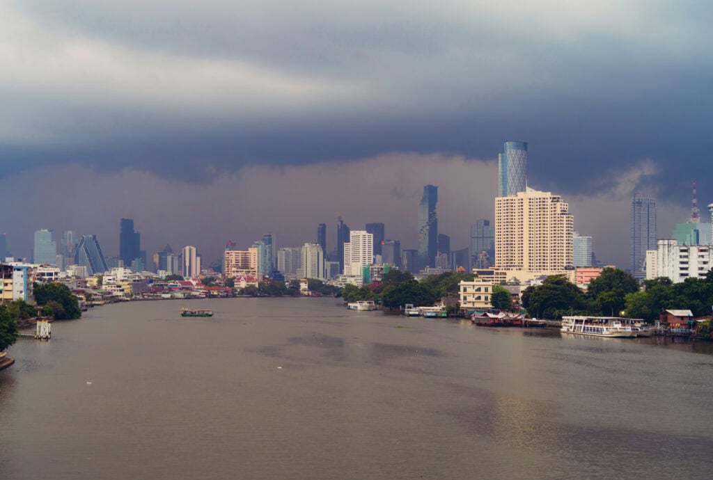 Skyline over river with dark clouds