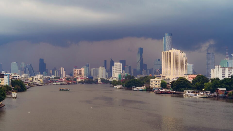 Skyline over river with dark clouds