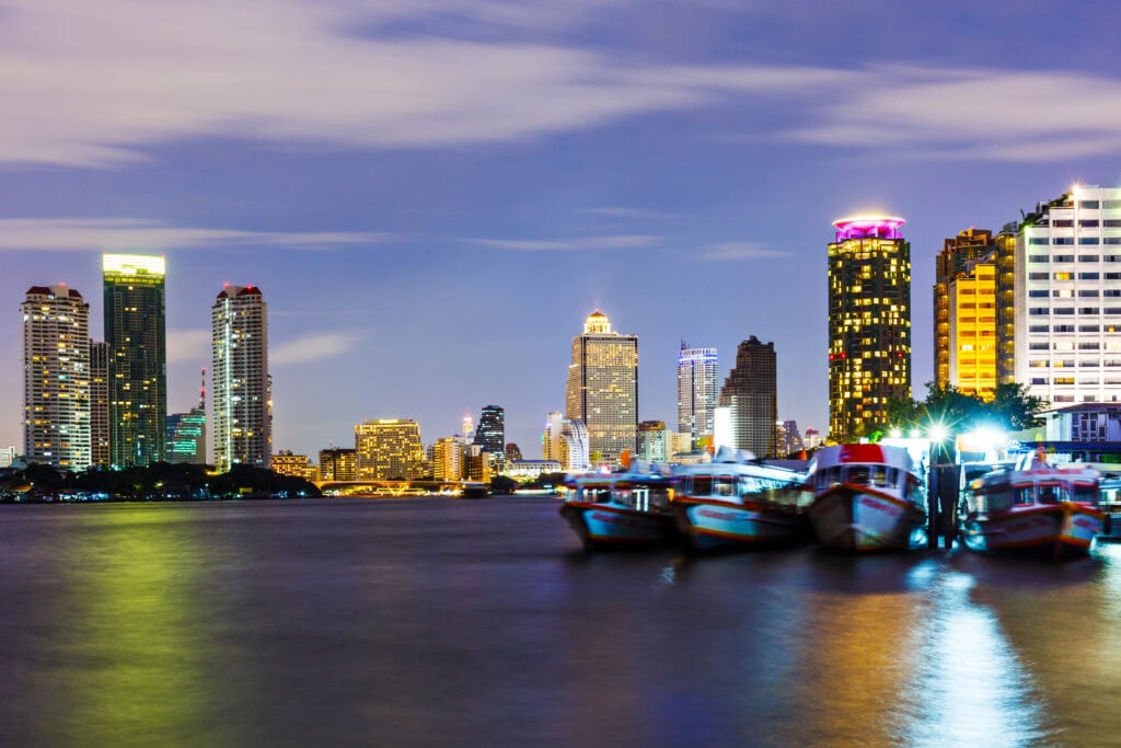 City skyline with illuminated buildings and boats