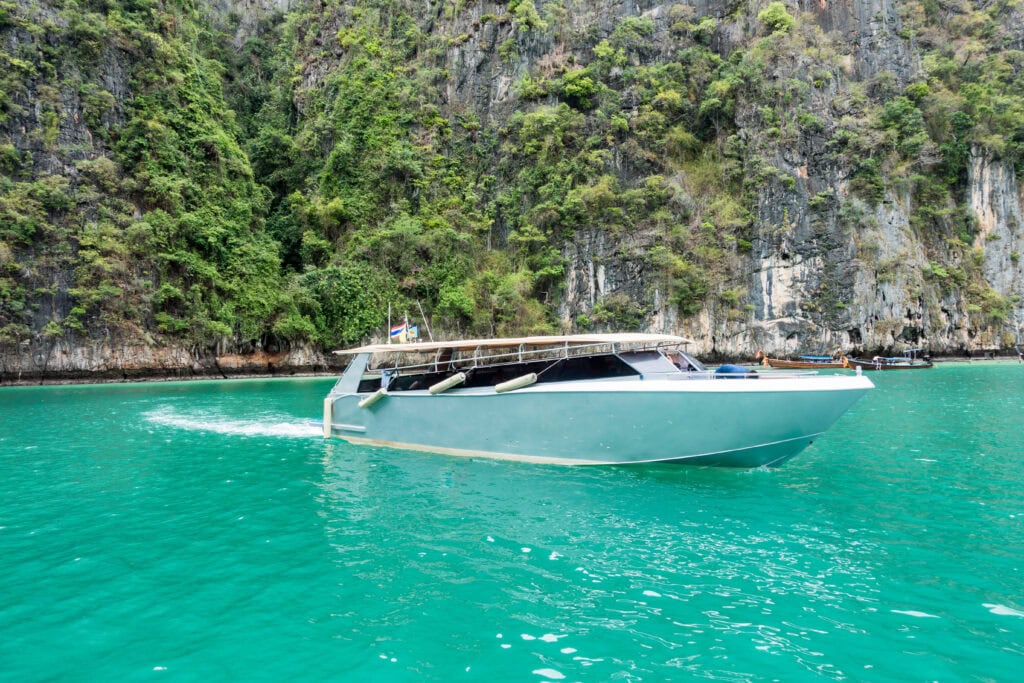 Speedboat navigating turquoise lagoon waters.