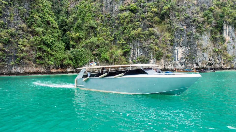 Speedboat navigating turquoise lagoon waters.