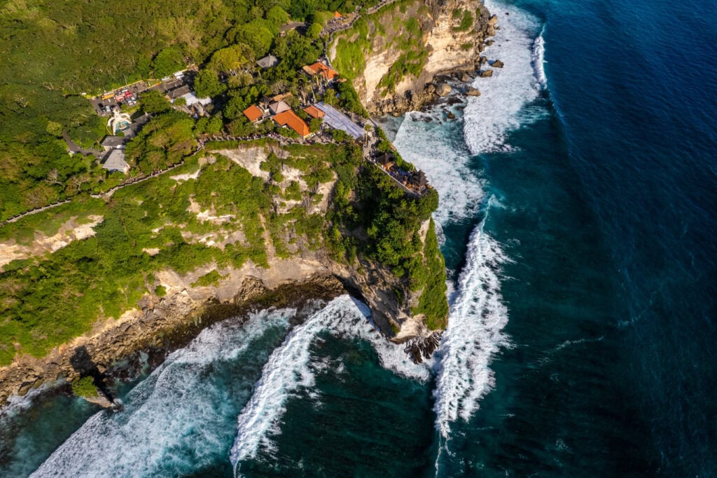 Cliffside temple overlooking ocean waves
