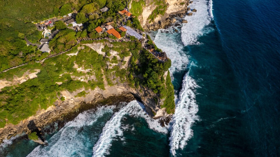Cliffside temple overlooking ocean waves