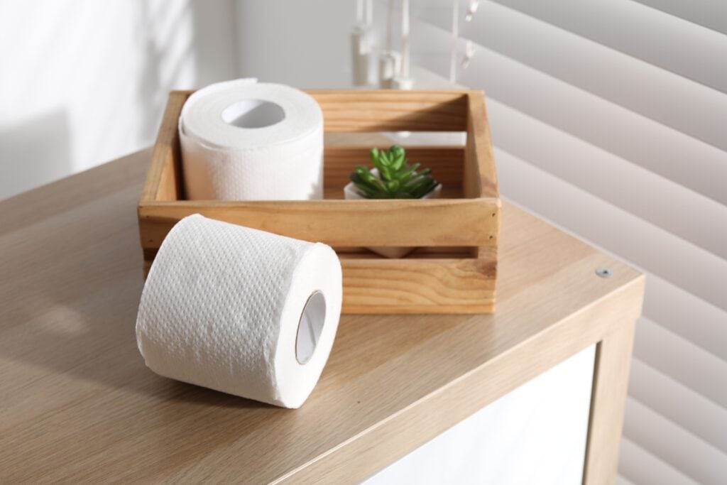 Toilet paper rolls on wooden table.