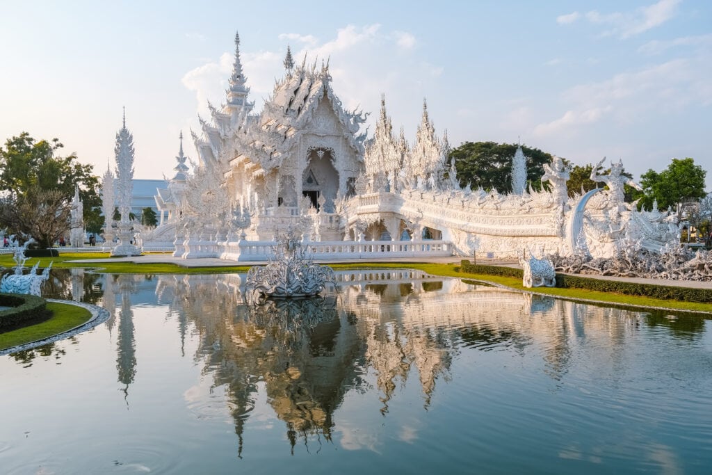 Stunning white temple reflecting in water.