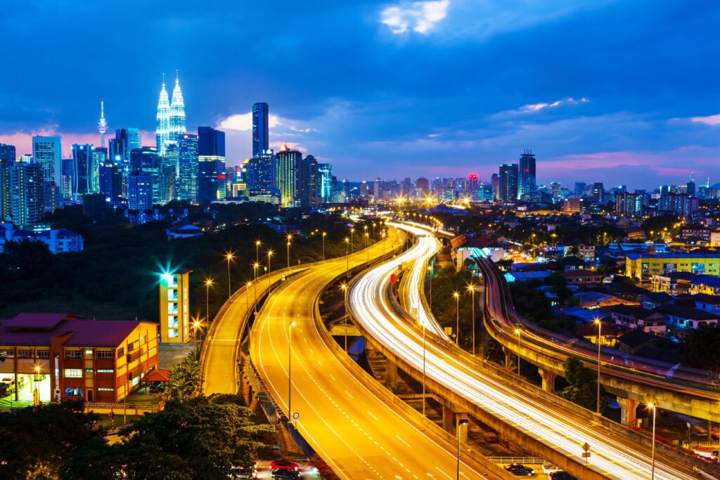 City skyline with illuminated highways at dusk