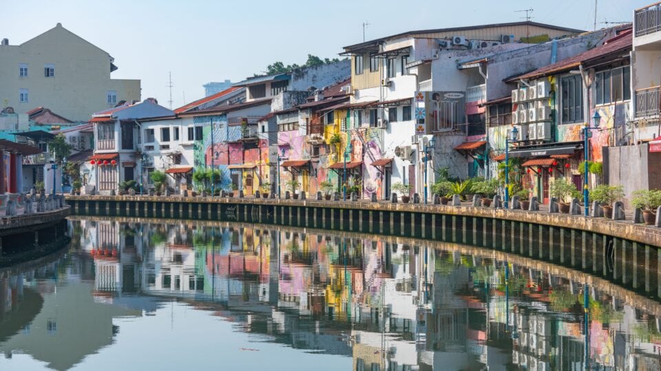 Colorful buildings reflecting in water.