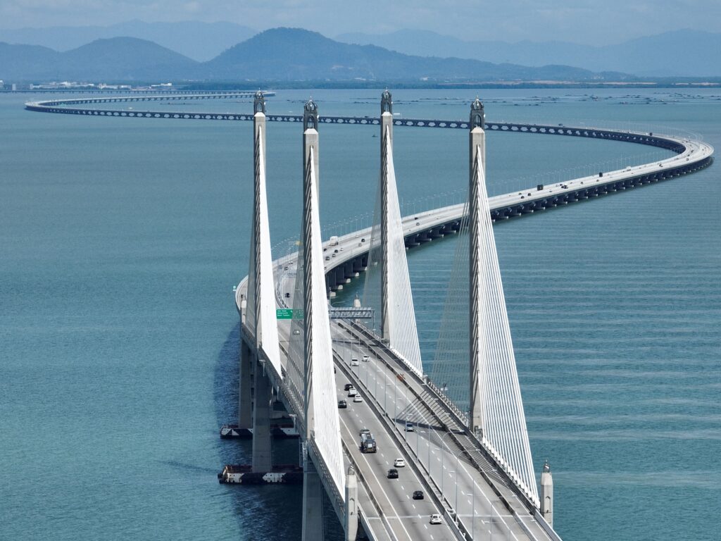 Curved bridge over calm blue waters