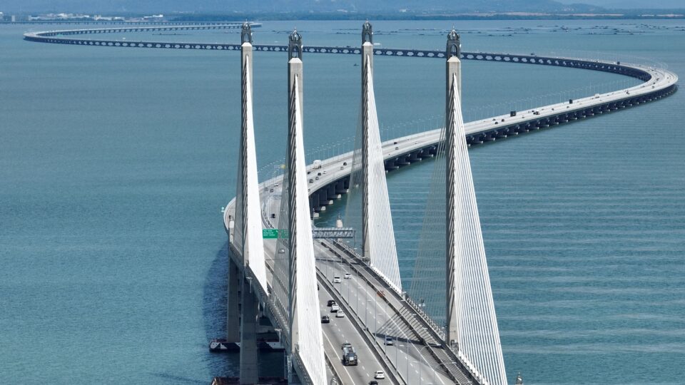 Curved bridge over calm blue waters