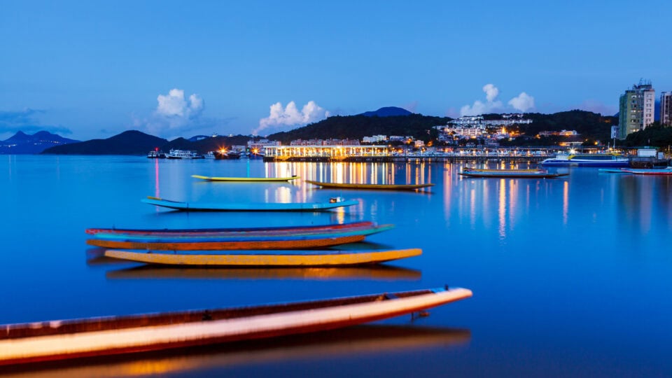 Boats on calm water at twilight.