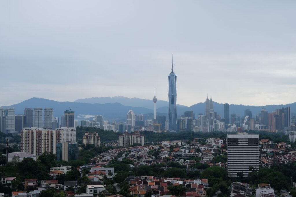 City skyline with tall buildings and mountains