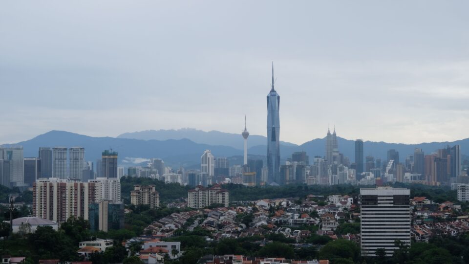 City skyline with tall buildings and mountains