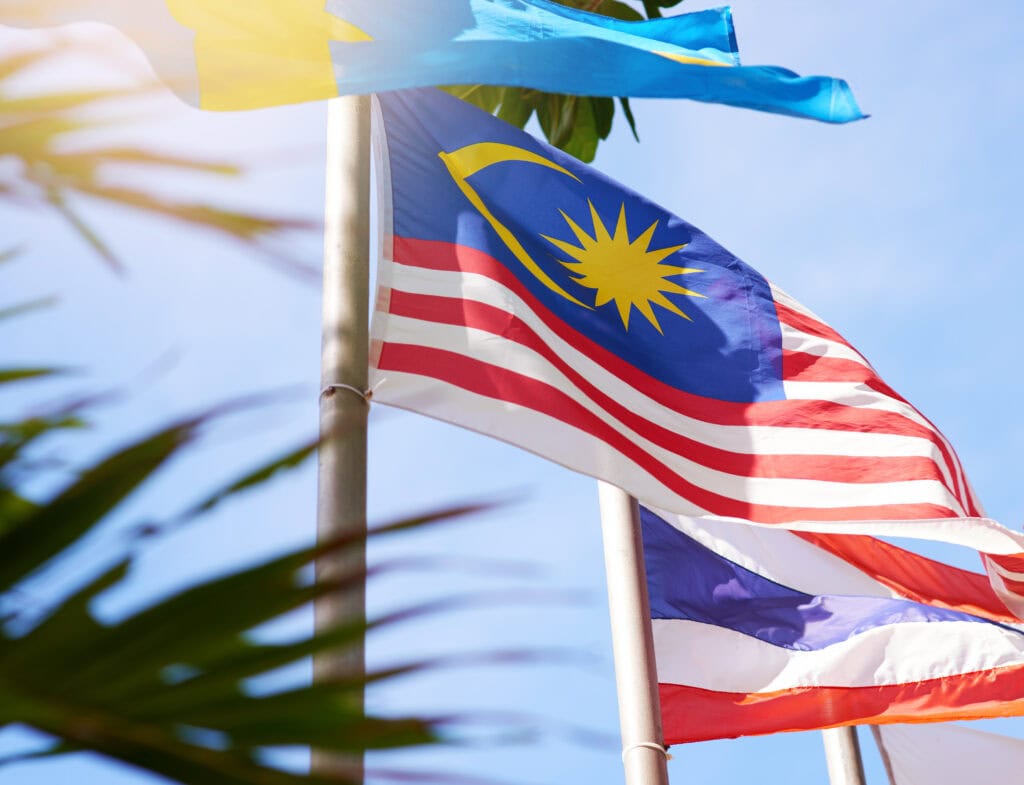 Flags fluttering against a blue sky.